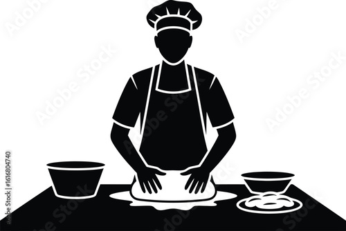 Baker kneading dough on table in kitchen silhouette