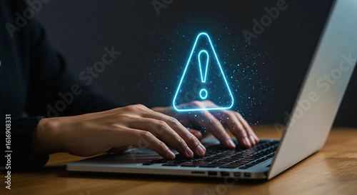 Cybersecurity specialist working on a laptop with a glowing warning sign, representing a critical security alert, data risk, or virus threat. This highlights the importance of digital protection and o