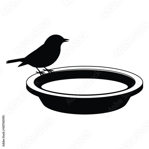 Silhouette of a small bird perched on the edge of a bird bath