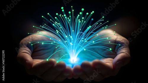Hands holding glowing fiber optics, symbolizing data transfer and innovation