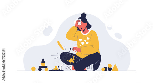 Exhausted mother sitting on the floor amidst scattered toys and spilled mess
