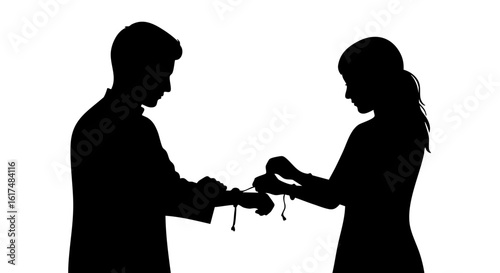 A Silhouette of brother tying a thread bracelet to sister's wrist