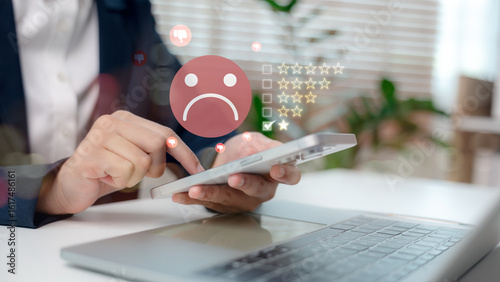 Φωτογραφία Customer giving one-star rating with unhappy face emoji on digital screen using tablet