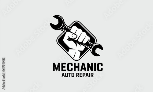 A fierce mechanic logo featuring a raised fist gripping a wrench exemplifies strength and skill within the automotive repair field, emphasizing dedication to quality workmanship.