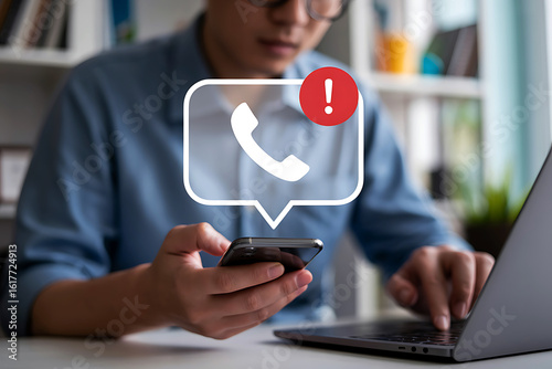 Person receiving a phone call notification while working on a laptop