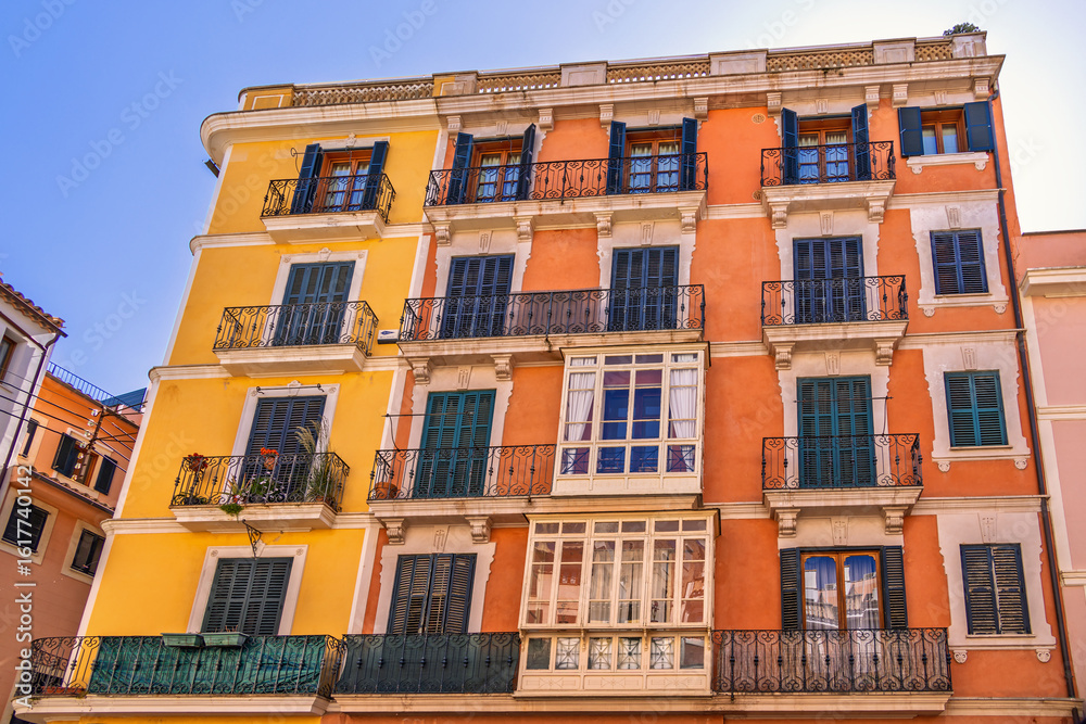 Fototapeta premium Spanish architecture on a residential building with balconies and shutters in a city