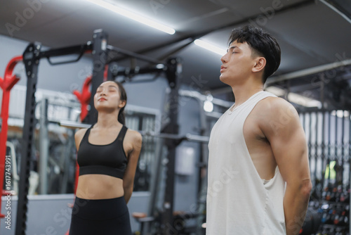 Athletes breathing deeply, recovering energy at the gym