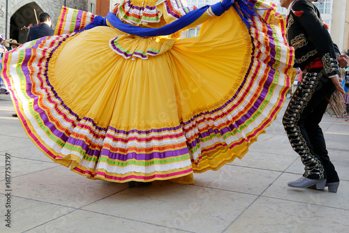 Dancers dancing and wearing one of the traditional folk costume from Mexico