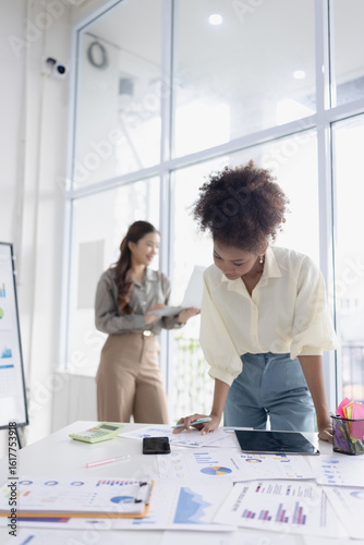 Two business woman working together for analysis data plan business strategies in office, Business discussing and startup concept.
