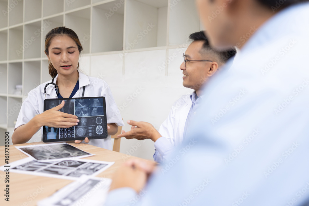 Fototapeta premium Medical team shows and explains MRI having a meeting in conference room at hospital, Medical technology and health care concept.