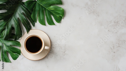 Pale-toned surface, coffee cup, tropical leaves