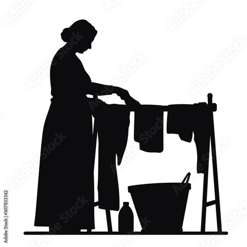 Dark silhouette illustration of woman hanging laundry to dry, classic silhouette in minimalist scene. Silhouette art conveys domesticity with clothesline, bucket and bottle for washing.