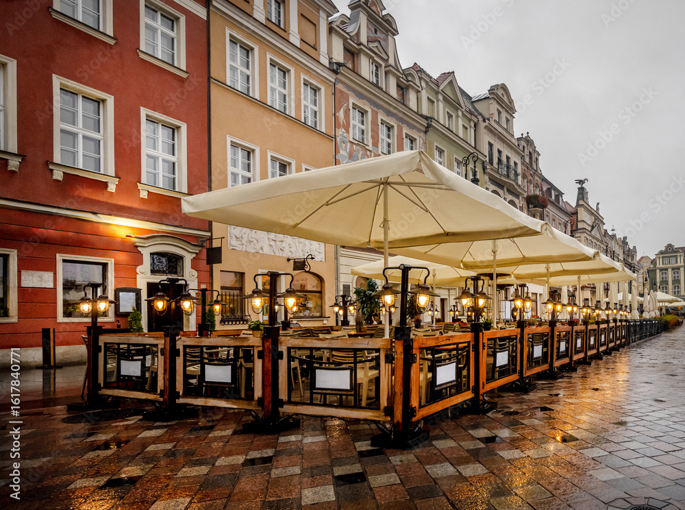 Naklejka premium Street Cafe Open In Poznan Evening After Rain