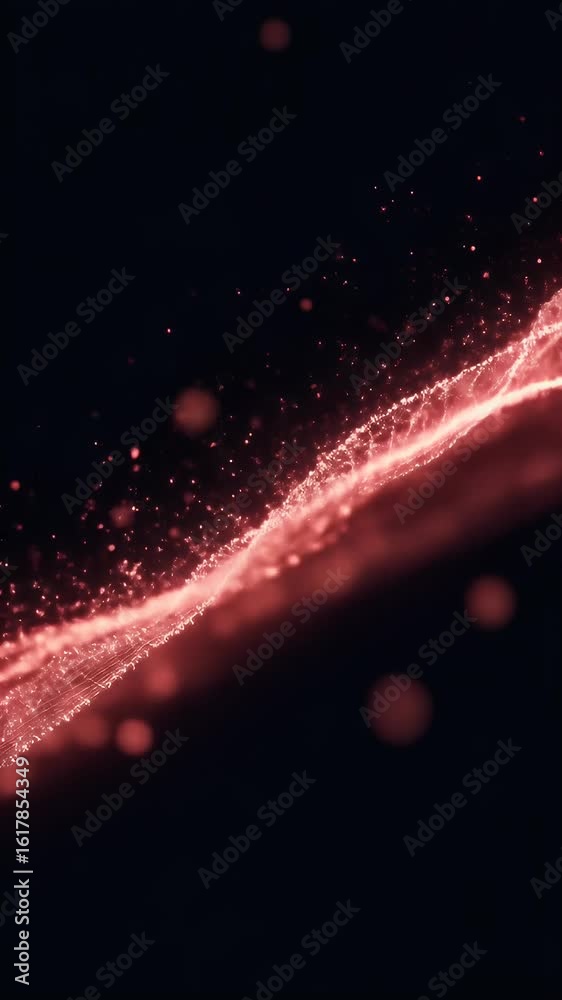 Abstract red particle stream flowing with dynamic energy against a black background