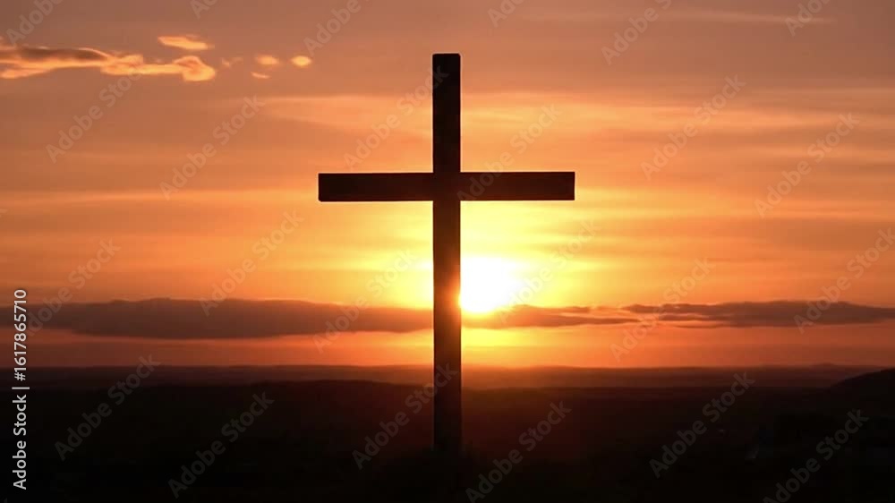 Silhouette of a cross against an orange sunset Silhouette of a cross against an orange sunset