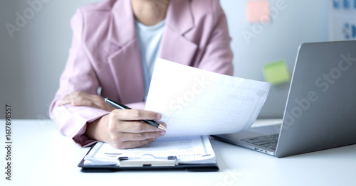 Business woman employer holding resume hiring recruit looking cv resume to hire candidates, analyzing information before job interview. Recruitment concepts