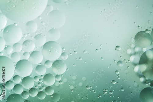 Close-up abstract macro of floating oil and water bubbles with creamy essence textures on soft gradients. Ideal for skincare, design, or wellness content.