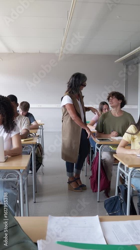 Teacher walking through classroom interacting with students in slow motion