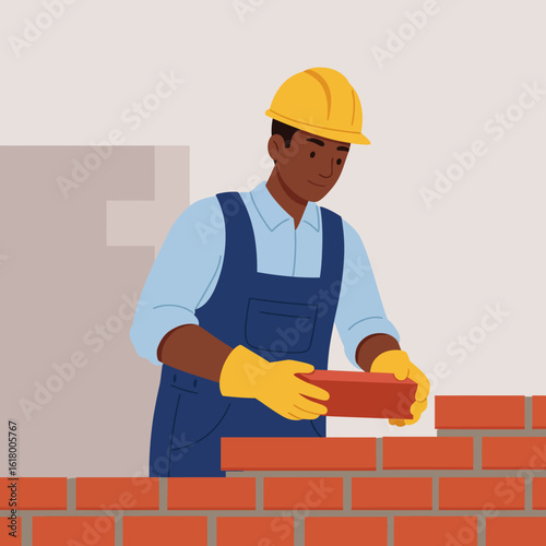 A construction worker, wearing a yellow hard hat and gloves, carefully places a brick while building a brick wall, demonstrating construction and craftsmanship.