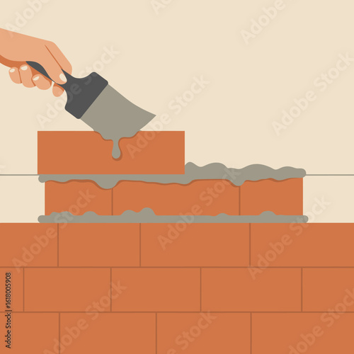 A human hand meticulously lays orange bricks with a trowel and grey mortar, illustrating the process of building a sturdy wall.