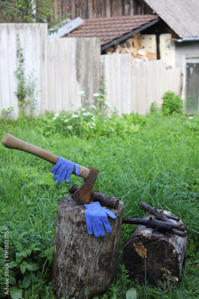 Naklejka premium chop wood. the axe lies on a wooden block in the yard
