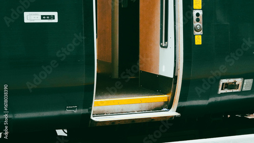 Valokuva Green colored train engine on rails in city landscape, modern transport scene