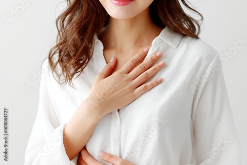 Young woman in a white shirt placing her hand on her chest with a sense of relief and gratitude  generated by AI