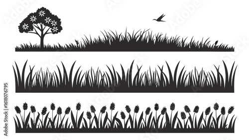 Silhouettes of a tree grass and reeds with a bird in the sky