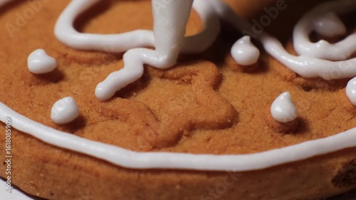 Christmas cookies are covered and decorated with white icing from a pastry bag. Handmade holiday sweets in the making
