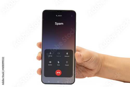 Wallpaper Mural A hand holds a smartphone displaying an incoming call identified as Spam on a Torontodigital.ca