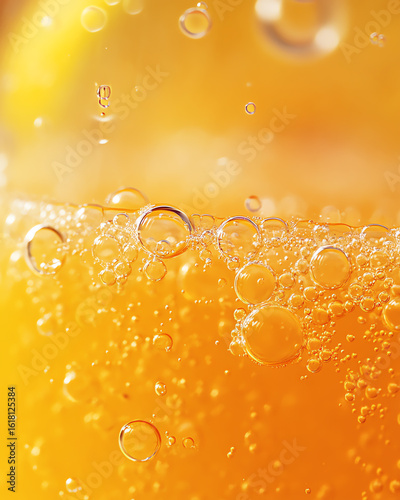 Close-up of refreshing orange soda with bubbles and vibrant color, perfect for summer drinks and beverage promotions.