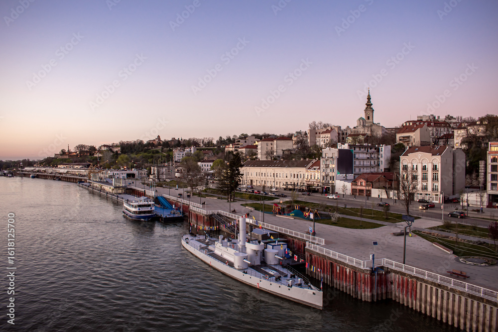 Fototapeta premium Belgrade, Serbia. A bridge over the Danube River. The city’s waterfront at sunset.