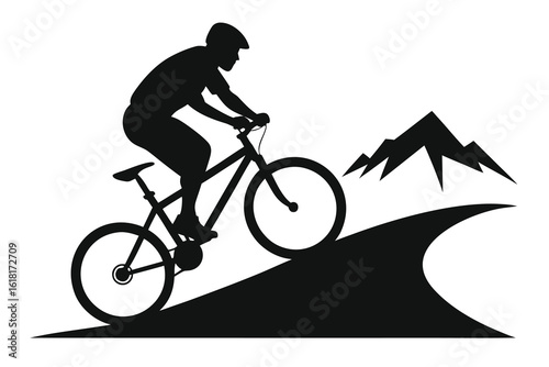 Black Silhouette of Mountain Biker Riding Uphill on a Trail with Mountain Backdrop