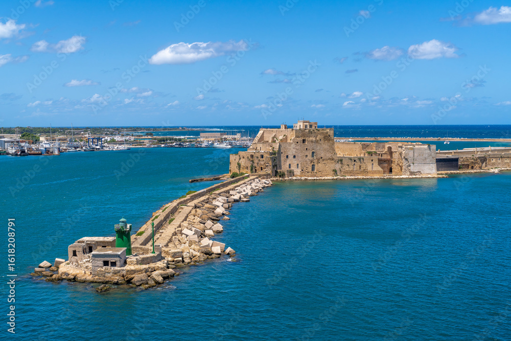 Fototapeta premium Aerial View of Venetian Fortress in the Sea, Alfonsino castle and lighthouse at the entrance to the port seen from a ferry boat while leaving, Brindisi, Puglia, Italy