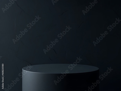 A dark grey cylindrical pedestal with a matte finish on a textured dark background