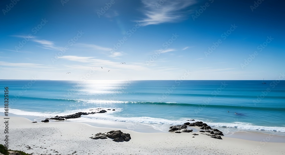Fototapeta premium Serene Beach Landscape with Calm Blue Waters, Rocks, and Distant Horizon View