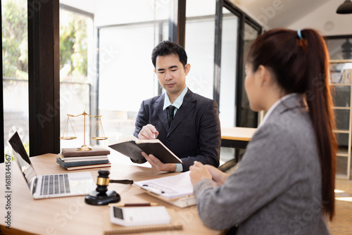 Lawyer with Document Paper and Hammer on Wood table,  Judge's Gavel, Law, Justice Symbol, Agreement and Partnership Concept,