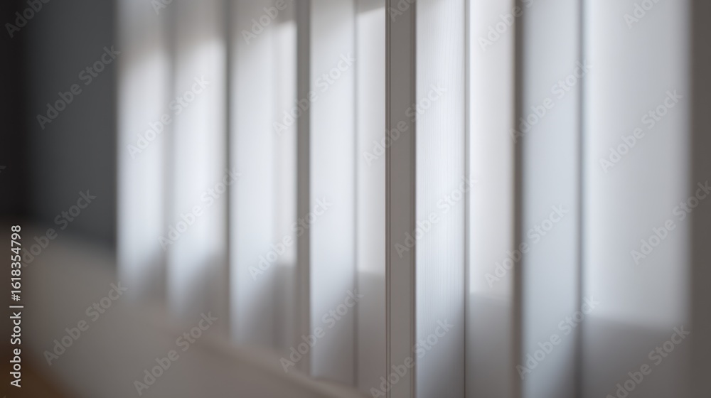 Obraz premium A blurred close-up of vertical blinds with soft light filtering through,