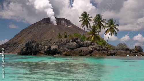 A volcanic island with palm trees and turquoise water, smoke billowing from the peak.
