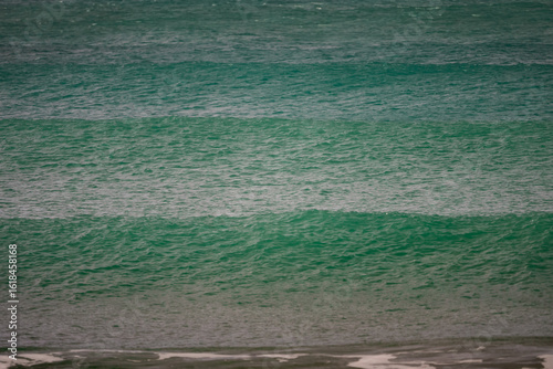 Waves of Praia do Rosa, Brasil. The power of the Atlantic after a huge storm. Big waves hitting the shore