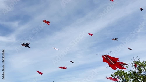 Kite Festival at the Mertasari beach in Sanur,  Bali. A lot of big kites flying on the blue sky