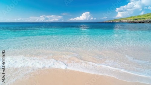 Wallpaper Mural Crystal clear ocean waves lap at sandy beach under bright sky with serene turquoise water Torontodigital.ca