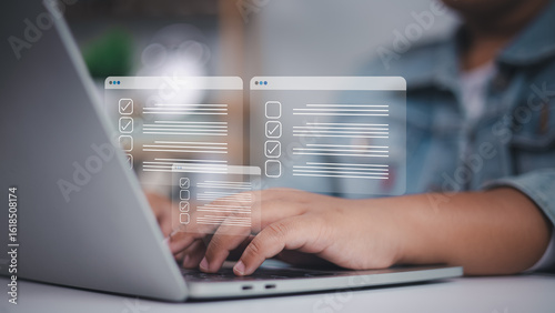 Photos Checklists, documents, and online forms appear in holographic windows as a person types on a laptop, representing digital surveys, data entry, and modern administrative efficiency
