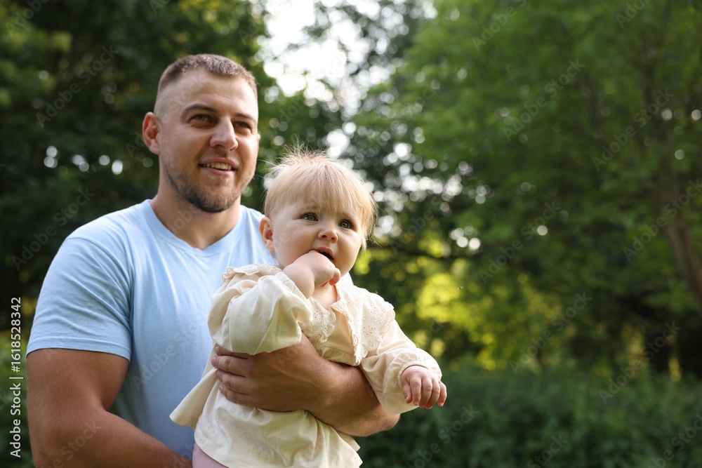 Fototapeta premium Smiling dad and his baby outdoors, space for text. Happy Father's Day