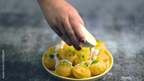 Close up of Indian street food fuchka on a plate glass with sour spicy water. Dahi Pani puri a chat item in India. 4K indian street food snacks.