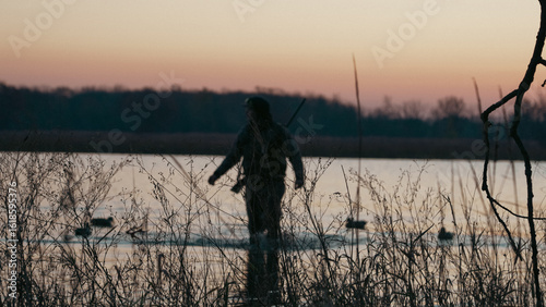 silhouette of a man duck hunting