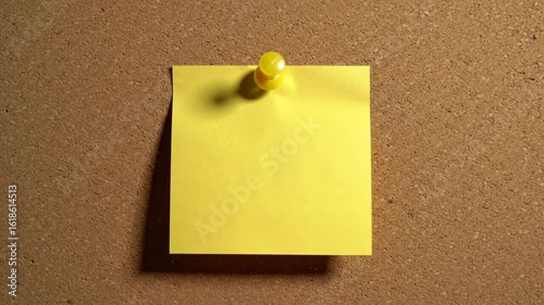 Yellow sticky note on corkboard