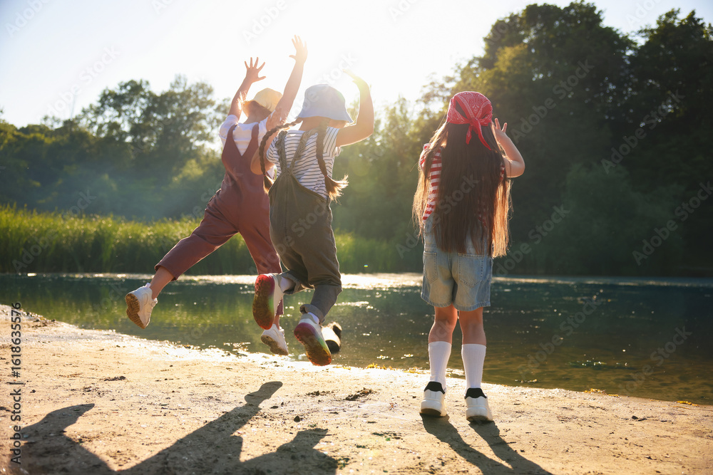 Obraz premium Cute little girls spending time in nature on sunny day
