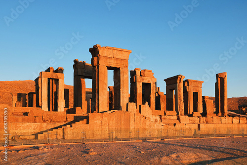 The Tachara Palace in Persepolis, Iran, is renowned for its scenic ruins, which are illuminated by sunset. The site was the ceremonial capital of the Achaemenid Empire. UNESCO World Heritage Site