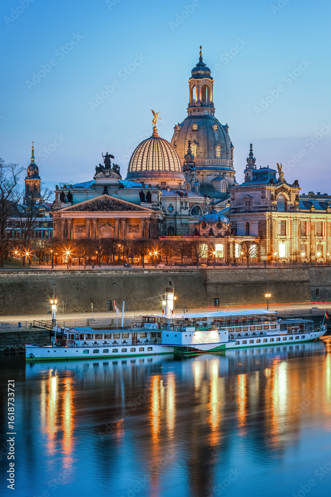 Fototapeta premium Panoramic view of Dresden old town from the Elbe riverbank, with baroque churches, domes, and historic buildings under clear sky. Famous cultural landmark in Saxony, Germany